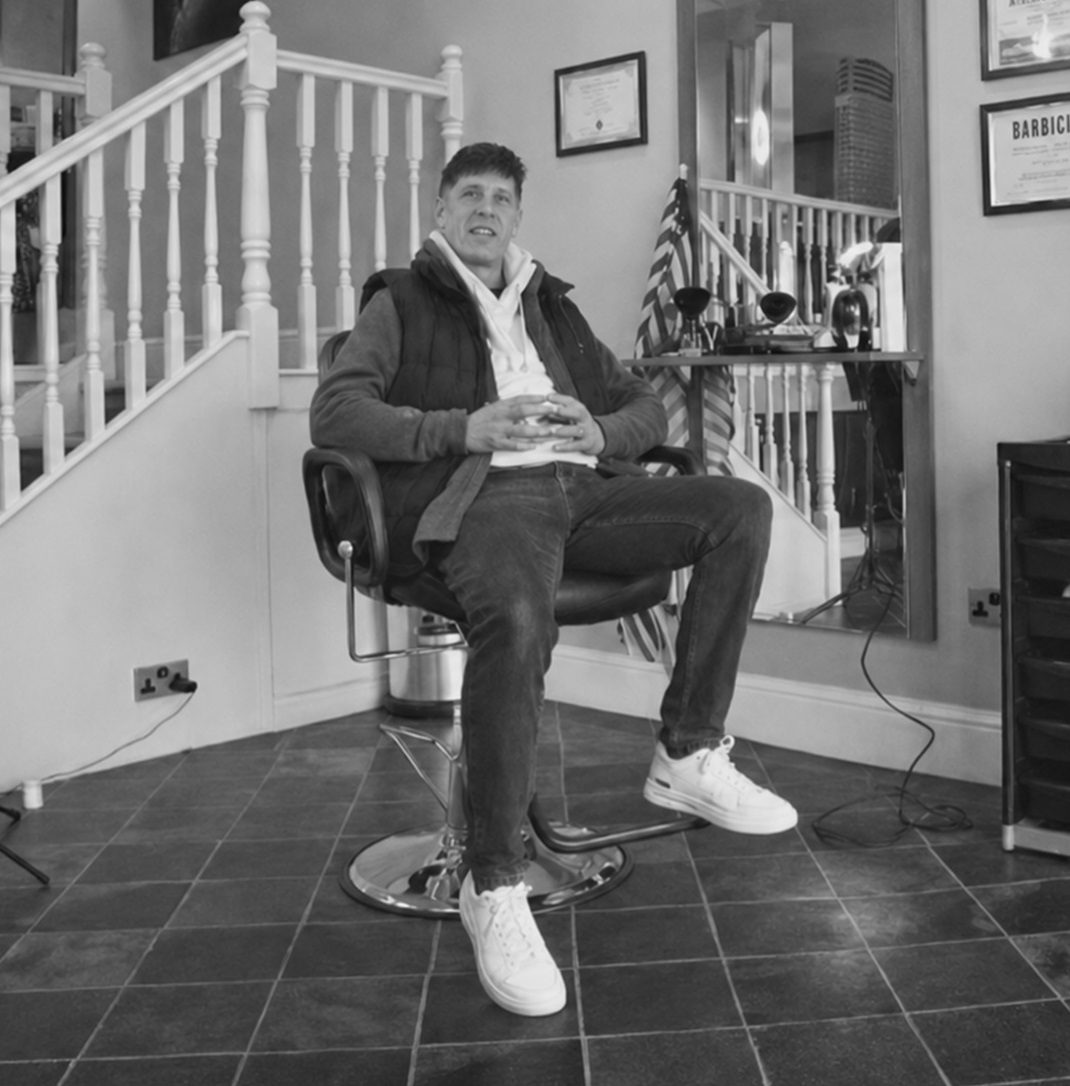 Andrew seated in his barber shop